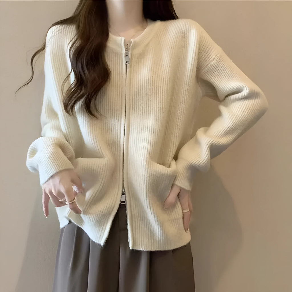Beige soft viscose knit cardigan with long sleeves shown on a hanger.
