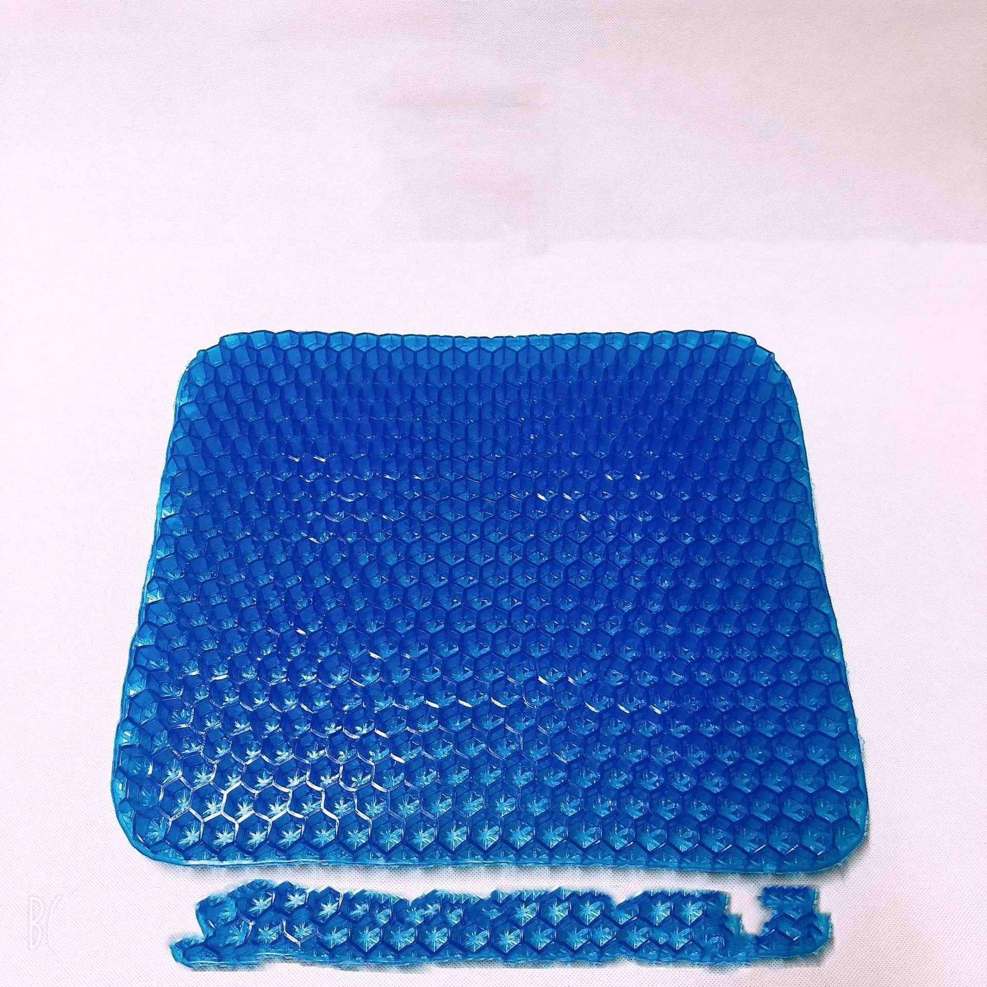 Grey double-thick gel seat cushion with honeycomb pattern, showing removable PVC cover.