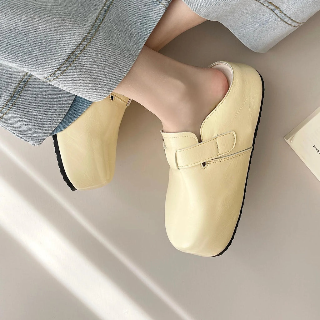 Flat buckle casual sneakers in yellow, black, silver, and creamy-white on a white background.