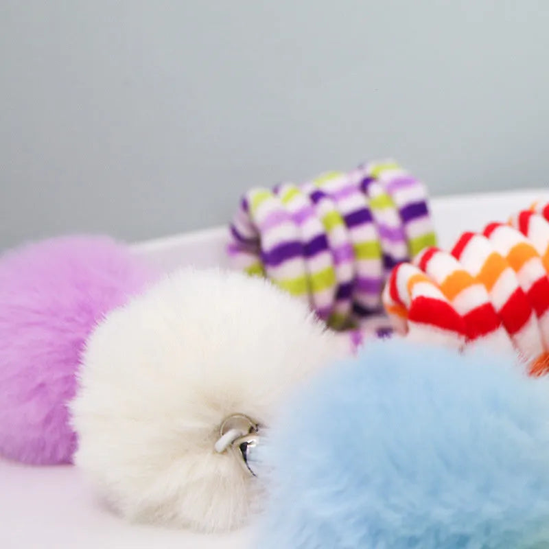 Colourful cat toy with spring bell stick and inflatable ball attached to a door by a suction cup