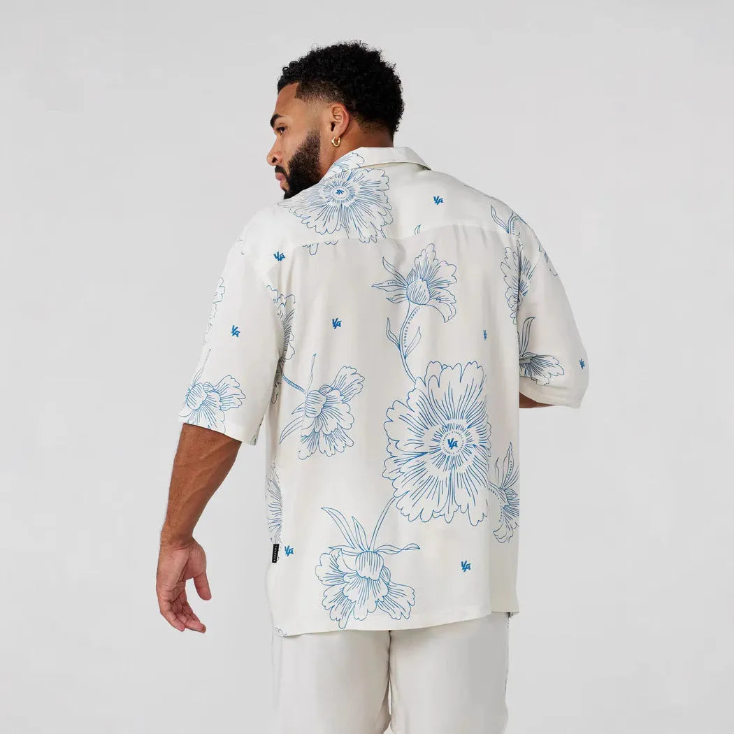 Men's loose fitting short sleeve top with floral print pattern in lightweight polyester fabric