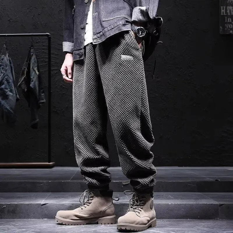 Men's grey straight-leg casual sweatpants with an ankle-tied design on a white background.