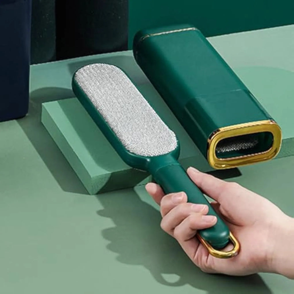 Blue double-sided pet hair remover brush with a storage box base on a fabric sofa.