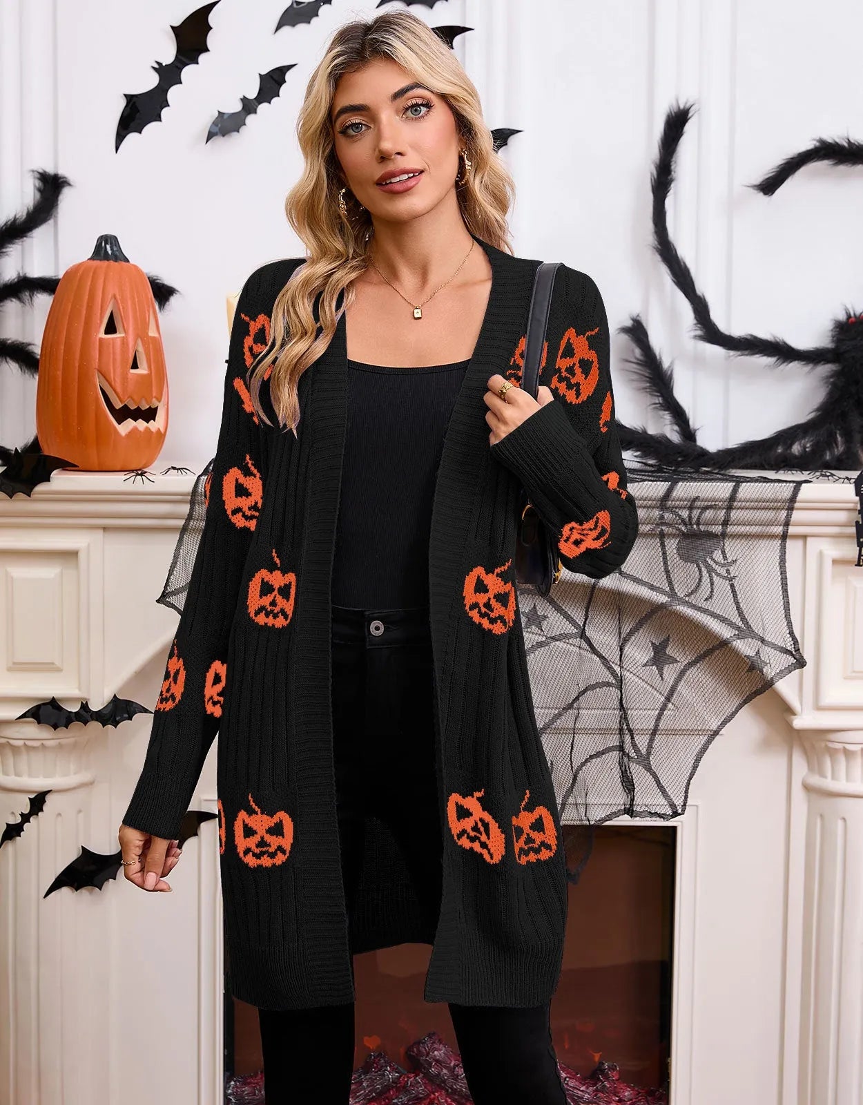 Women's black knitted cardigan with an orange pumpkin head jacquard pattern and regular sleeves.