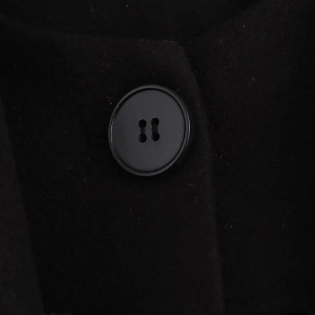 Women's long grey wool blend overcoat with a large artificial fur collar and pockets.