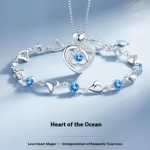 Blue diamond heart necklace and bracelet set with adjustable chain on display