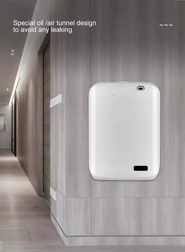 White smart wall mount essential oil diffuser with 150ml tank on a beige wall.