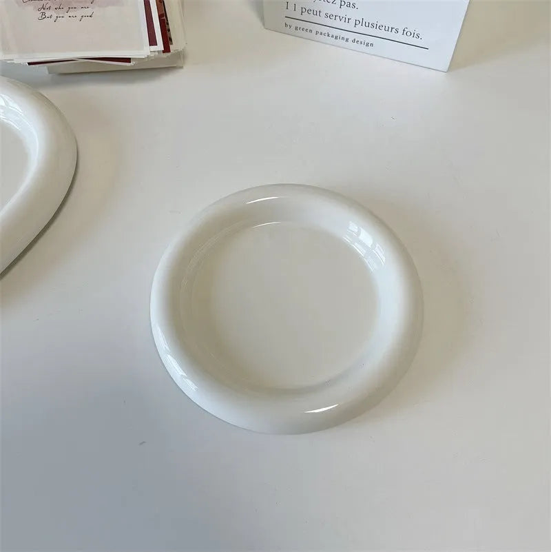 White porcelain plate with chubby toot or bear doodle pattern, shown in 15cm and 20cm round sizes.