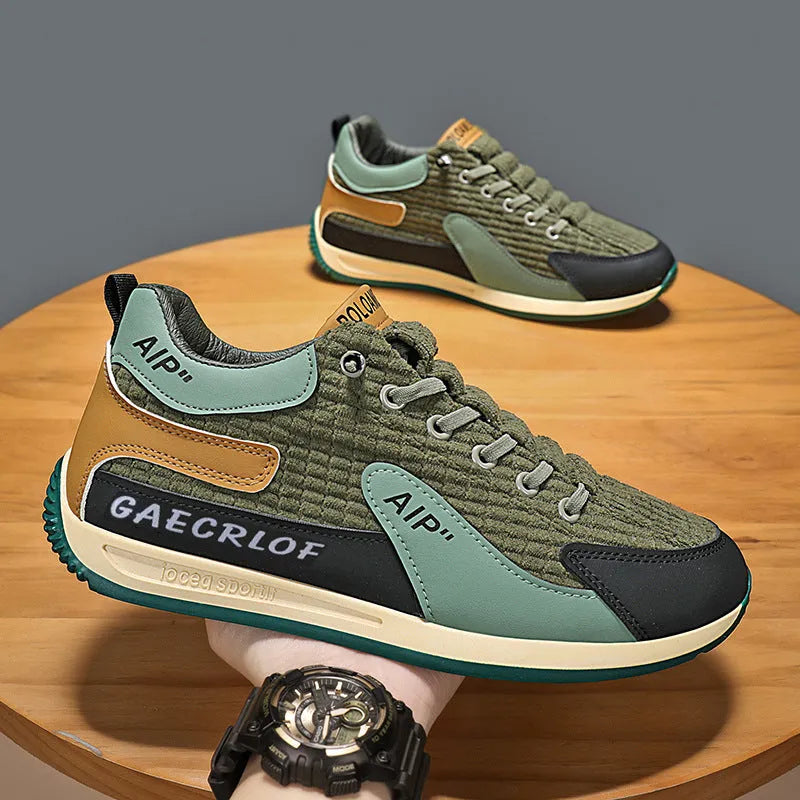 Men's grey and green mesh running shoes with round toe and lace-up design shown from side view