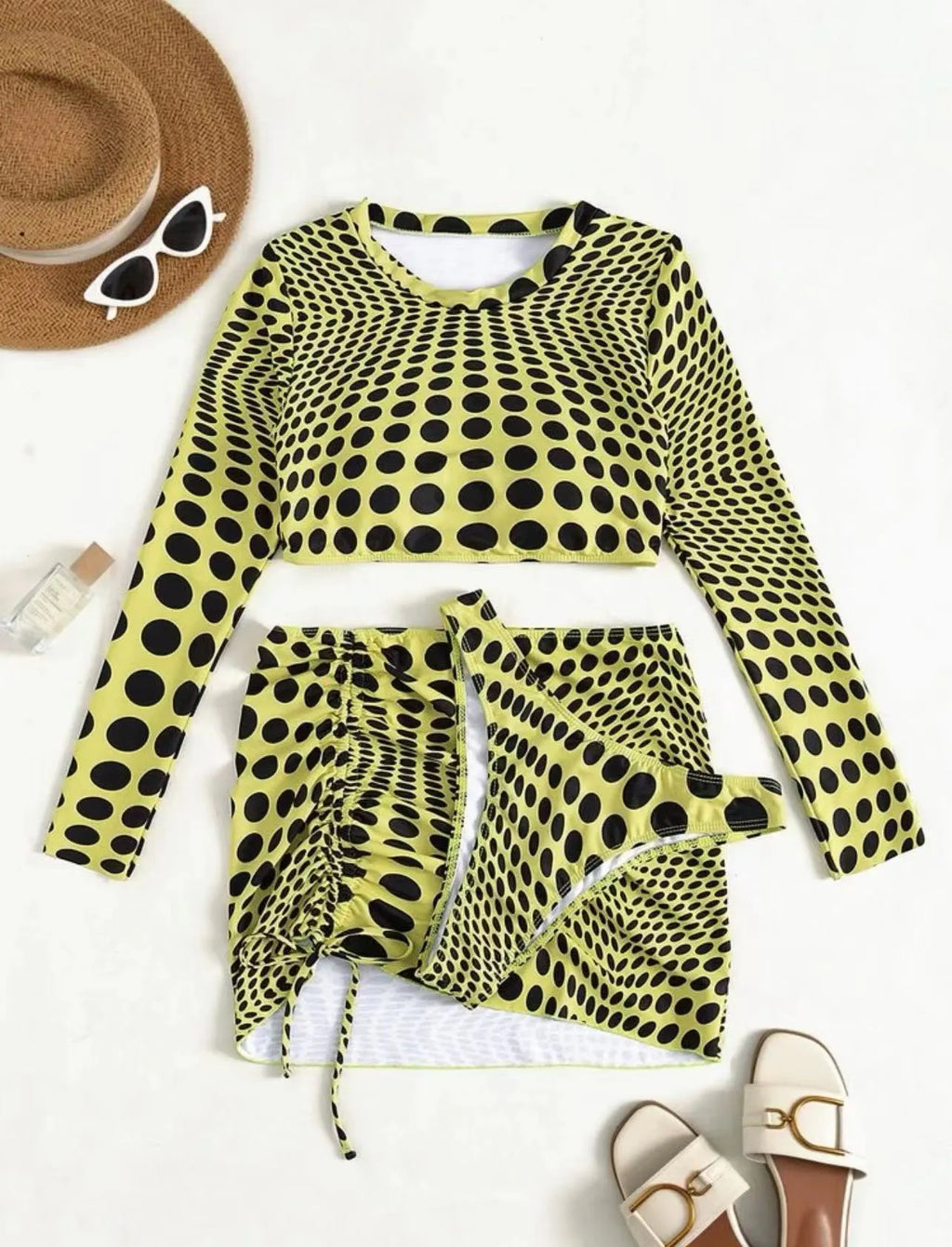 Green and yellow polka dot women's swimsuit three-piece set with top, skirt, and bra.