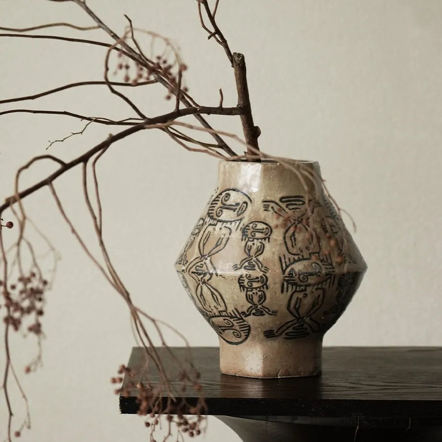 Hand-painted ceramic vase with carved tribal totem flower pattern in cylindrical shape