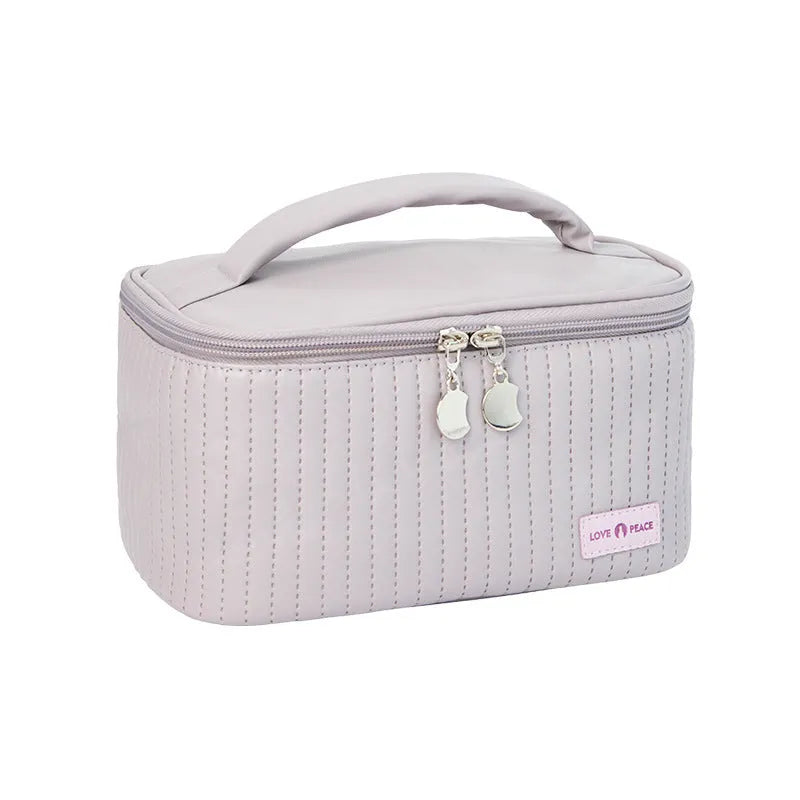 Open-top pink PU leather cake-style makeup bag on a table