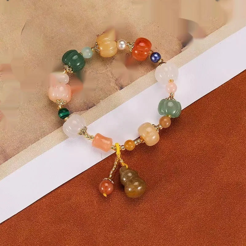 Carved pumpkin lotus bodhi root bracelet with white jade segments and golden silk jade treasures