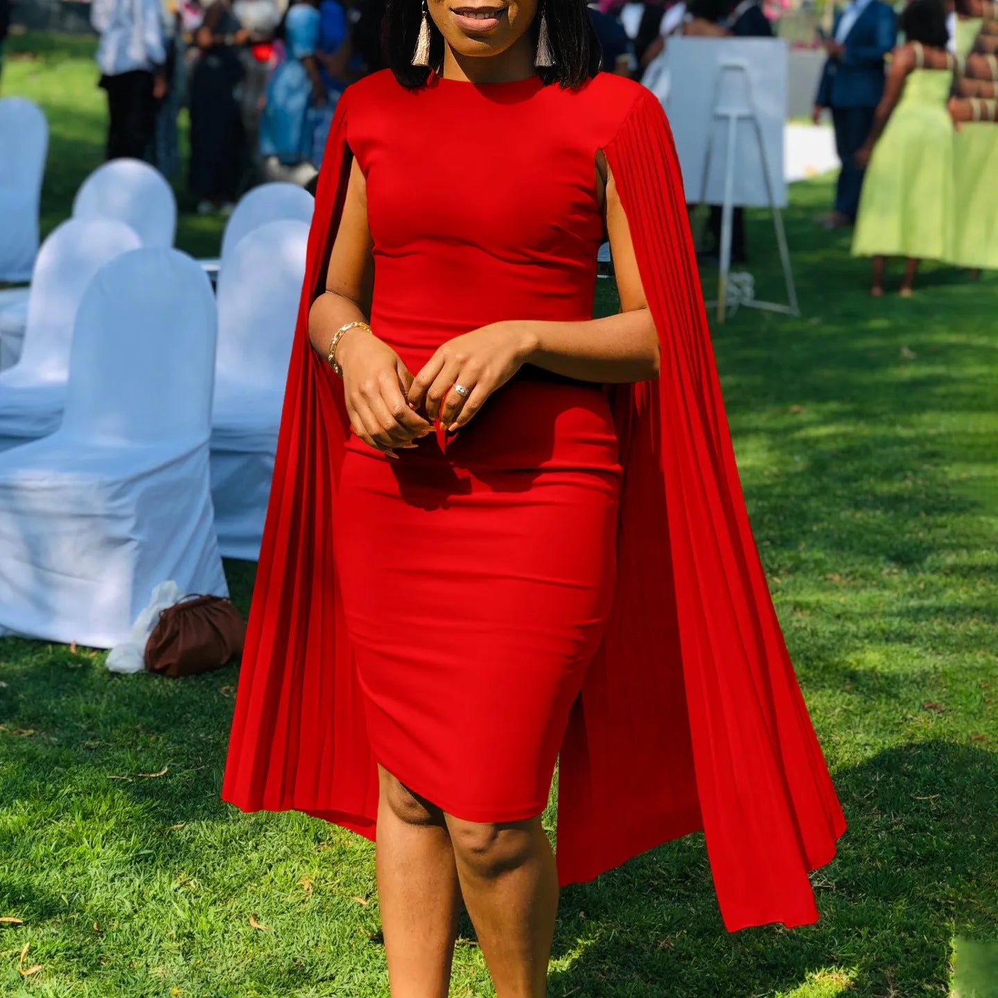 Long sleeve evening dress with pleated shawl detail in red, shown with high waist