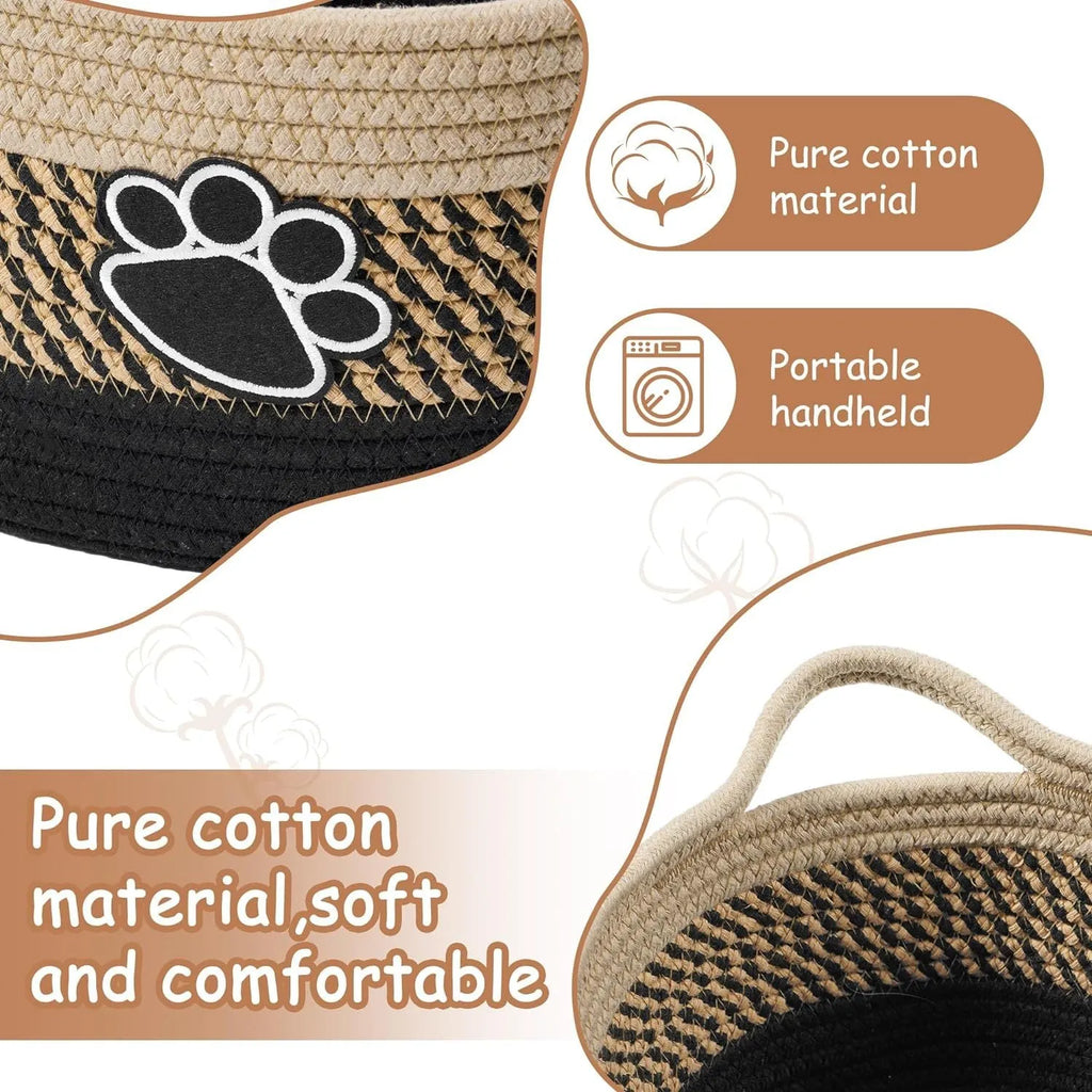 Light beige handmade woven cotton rope storage basket with a handle on a wooden surface.