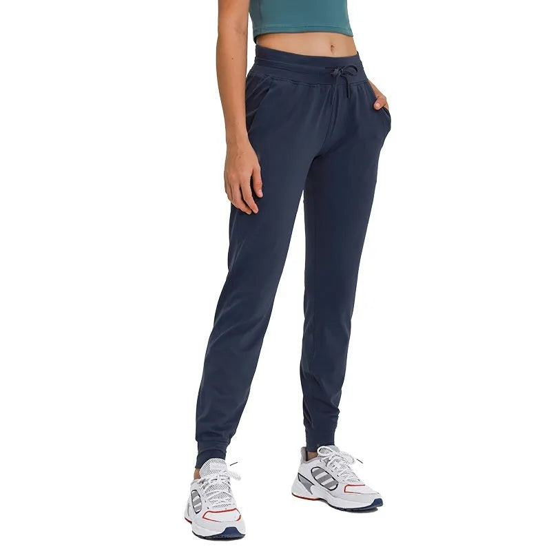 Women's high waist yoga pants in Belgian Blue colour with a drawstring waistband, shown flat.