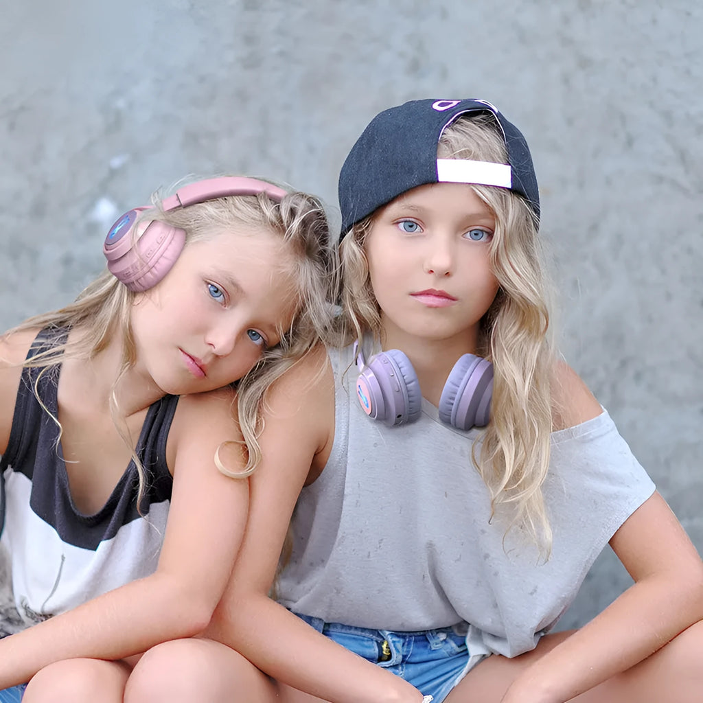 Wireless RGB LED headphones for children in bunny pink with lights illuminated