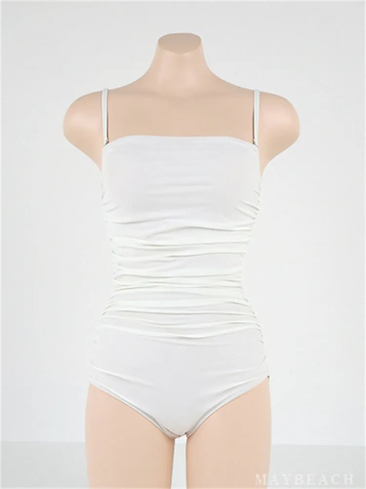 Blue sling style one-piece swimsuit with belly pleating on a mannequin