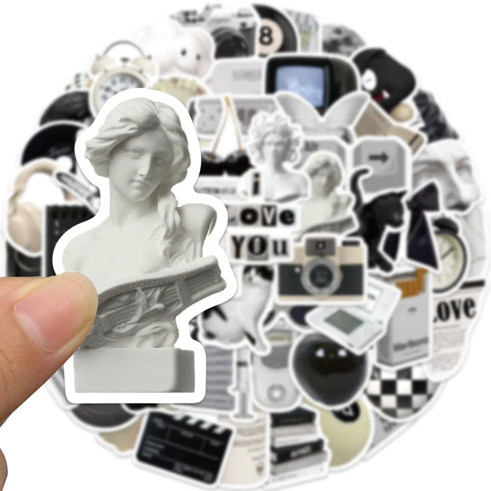 61-piece black and white waterproof PVC sticker set for laptops, phones, and luggage.