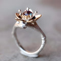 Silver and rose gold two-tone floral design alloy ring on a geometric band.