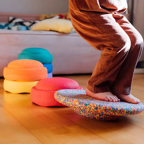 Children's plastic surf-shaped balance board in mixed wood colour and solid black option.