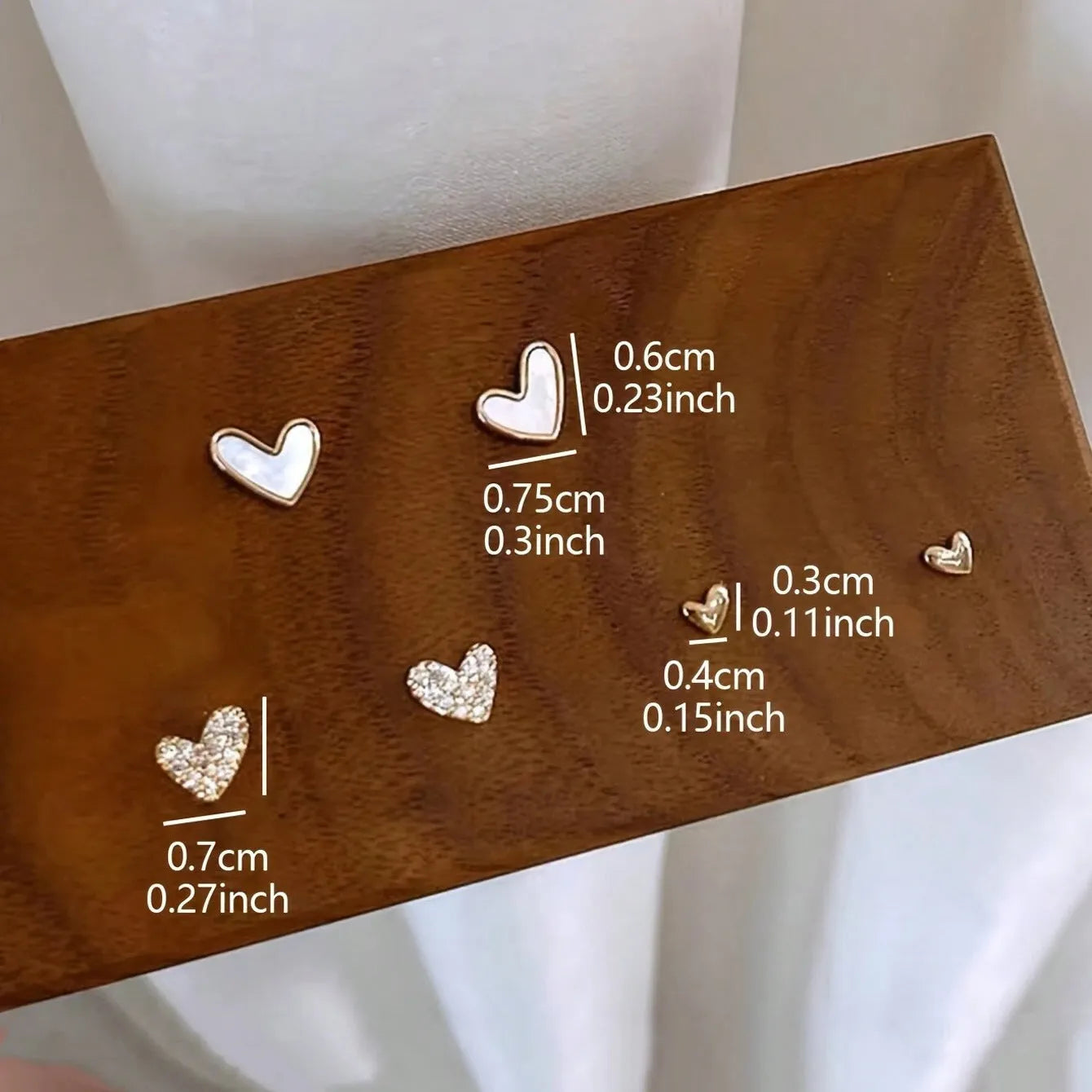 Three pairs of heart-shaped alloy earrings with love motifs in four colour options