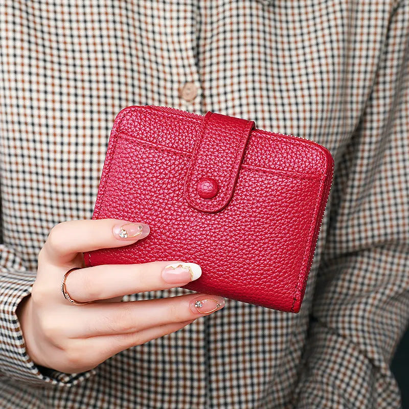 Women's short PU leather wallet with lychee pattern in beige, pink, black, or red.