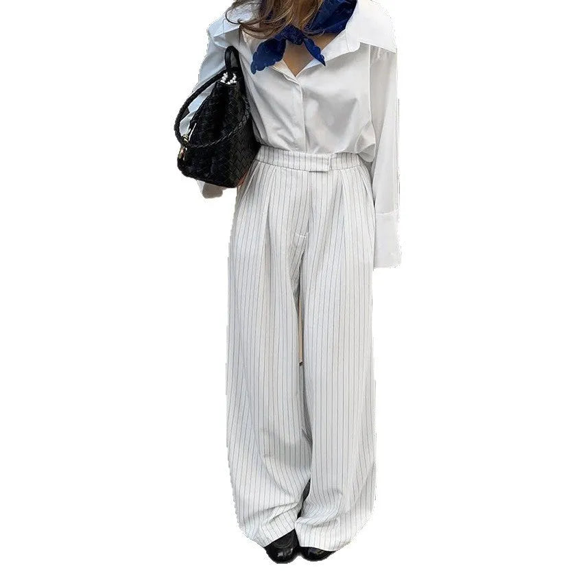 White striped wide-leg women's trousers with front zipper in loose casual fit
