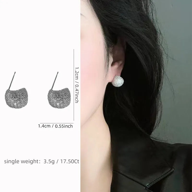 Geometric drop-shaped ear clips with full diamond detailing and sphere elements in gold and white colour options