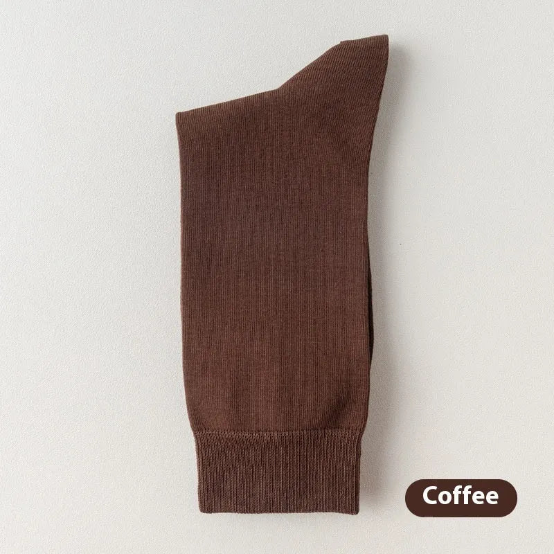 Men's solid colour pure cotton mid-calf business socks in beige, black, grey and blue shown folded.