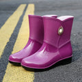 Women's purple PVC rain boots with non-slip sole and middle tube design