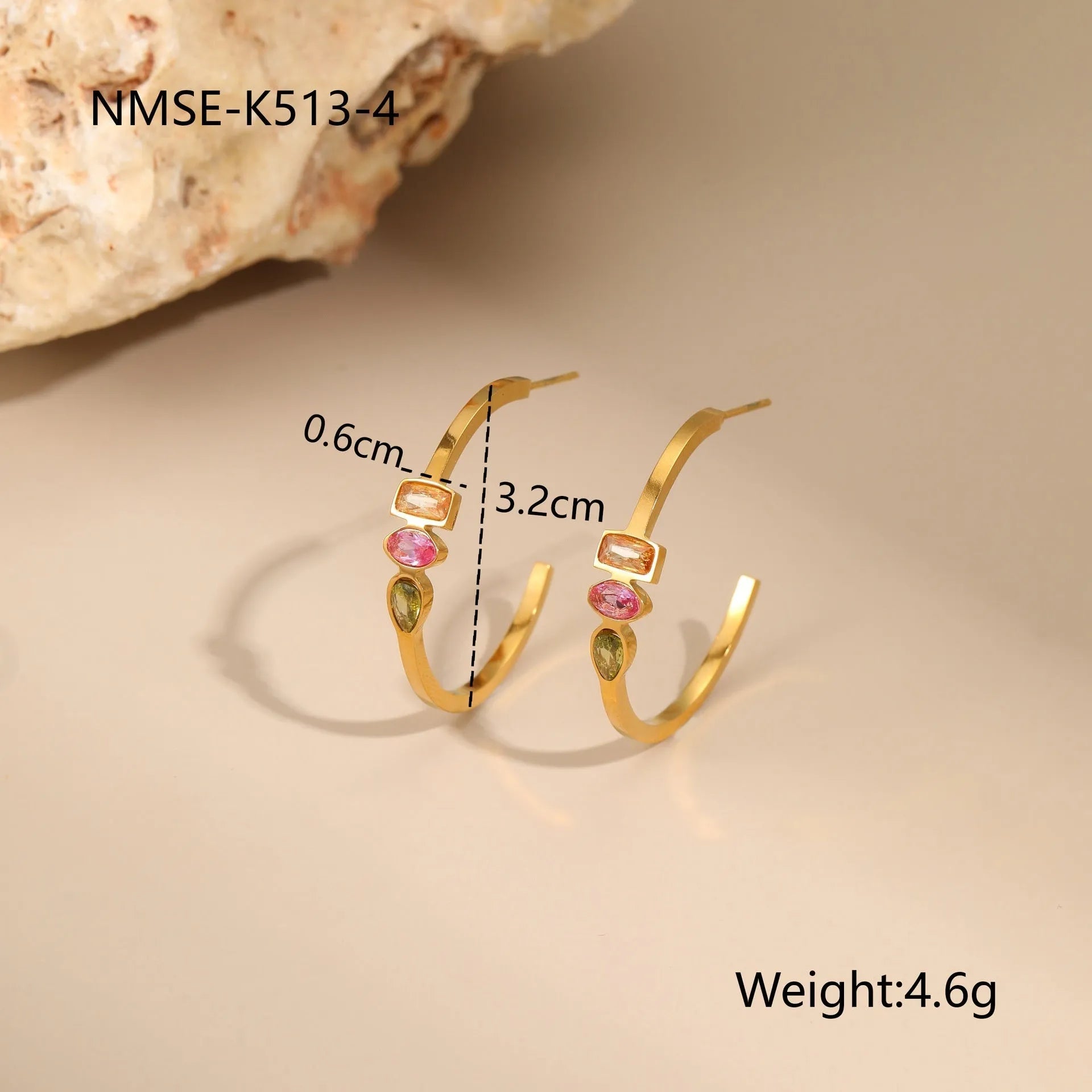 Geometric gold-plated necklace, ring, and earrings set with an adjustable chain on a grey background.