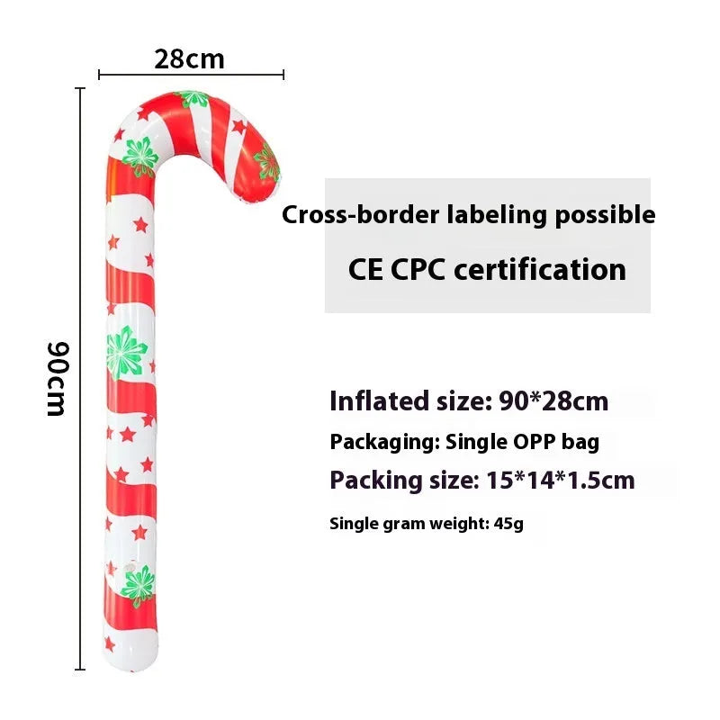 Large red and white inflatable Christmas ball with snowflake design in garden setting