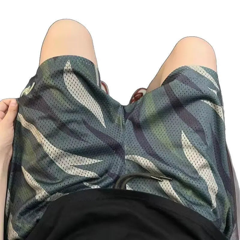 Men's camouflage pattern mesh shorts in cotton blend fabric showing straight cut design