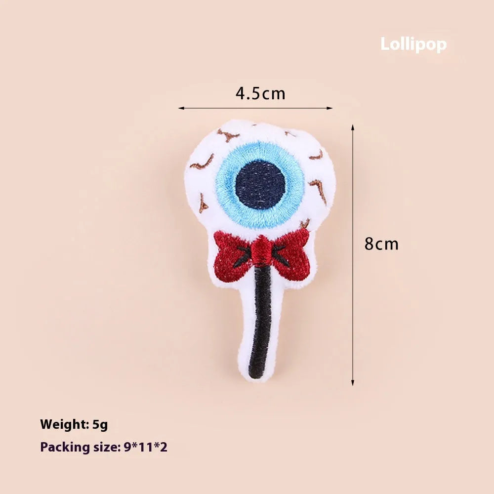 Colourful plush cat tease stick with candy, eyes and skull designs on small wand toy