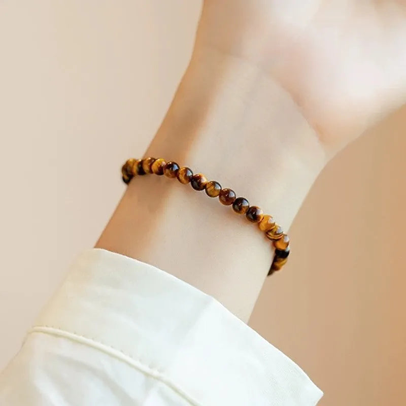 A geometric New Chinese style unisex bracelet made from round Tigereye stone beads.
