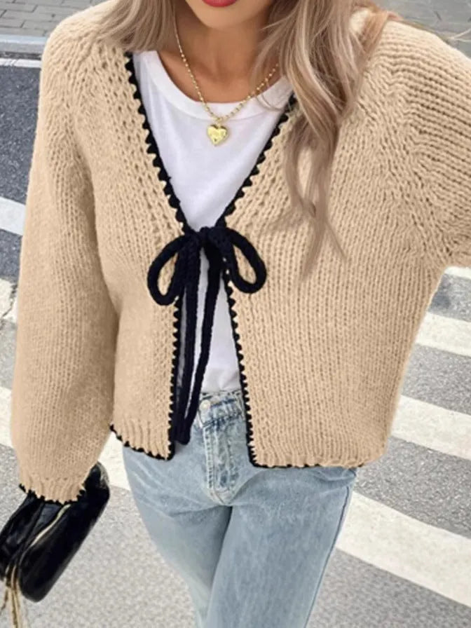 Grey lace-up sweater cardigan with long sleeves, a front crocheted flower, and a loose fit.