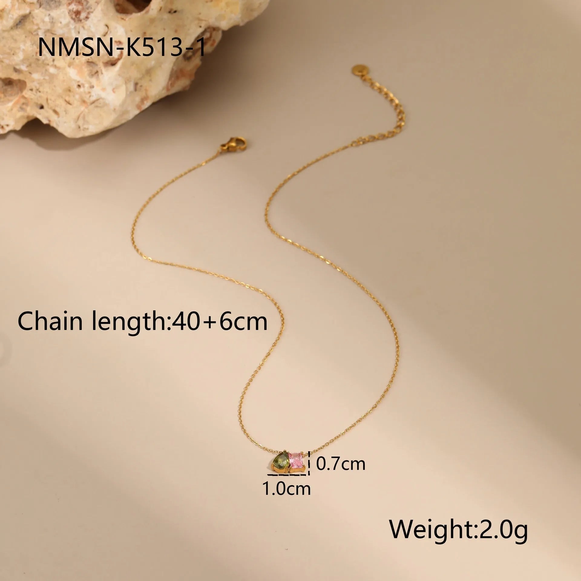 Geometric gold-plated necklace, ring, and earrings set with an adjustable chain on a grey background.