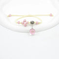 Close-up of a hand-woven glass bracelet with large 1.4cm beads containing real dried flowers in various colours.