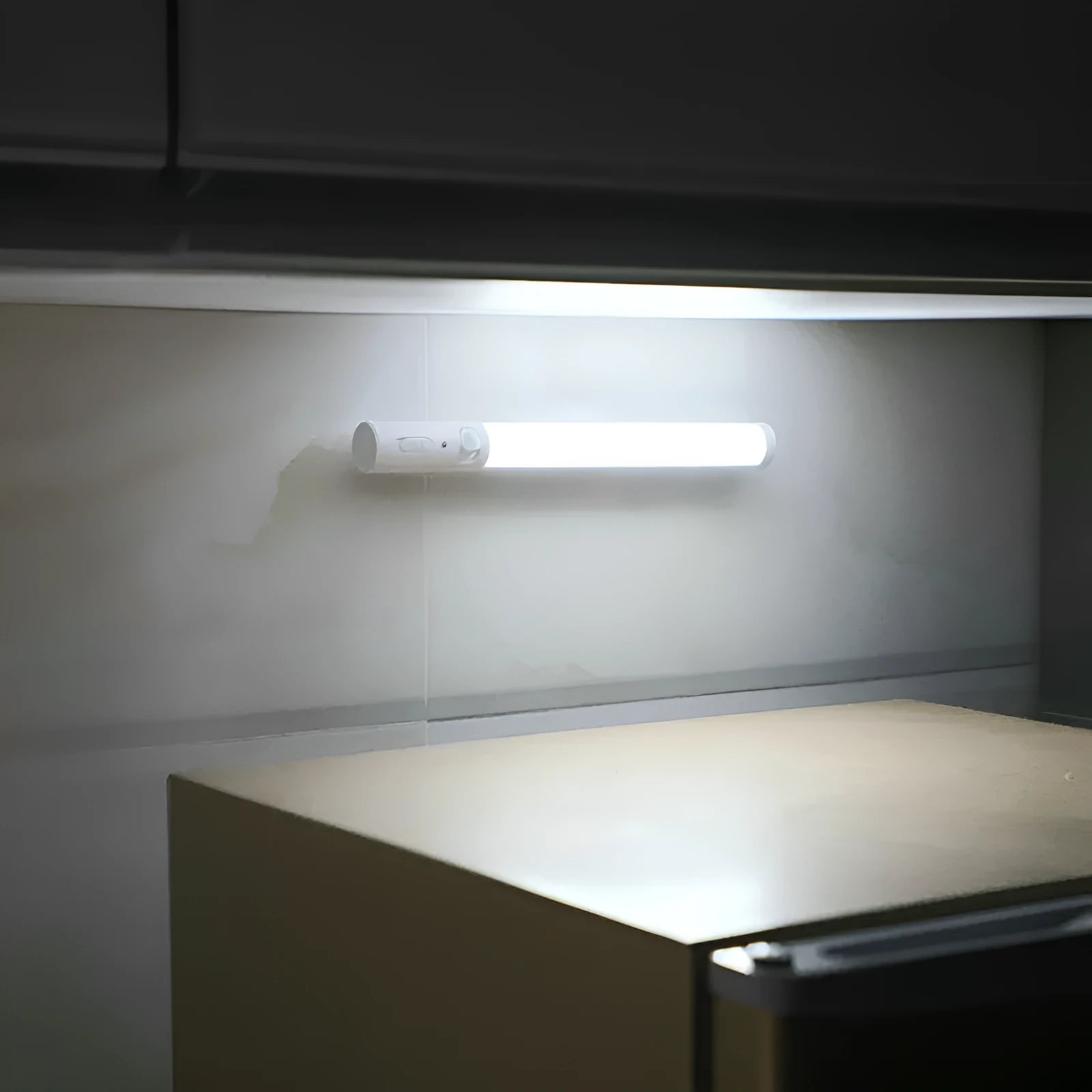 A slim 260mm long white LED strip light with a magnetic back for cabinet mounting.