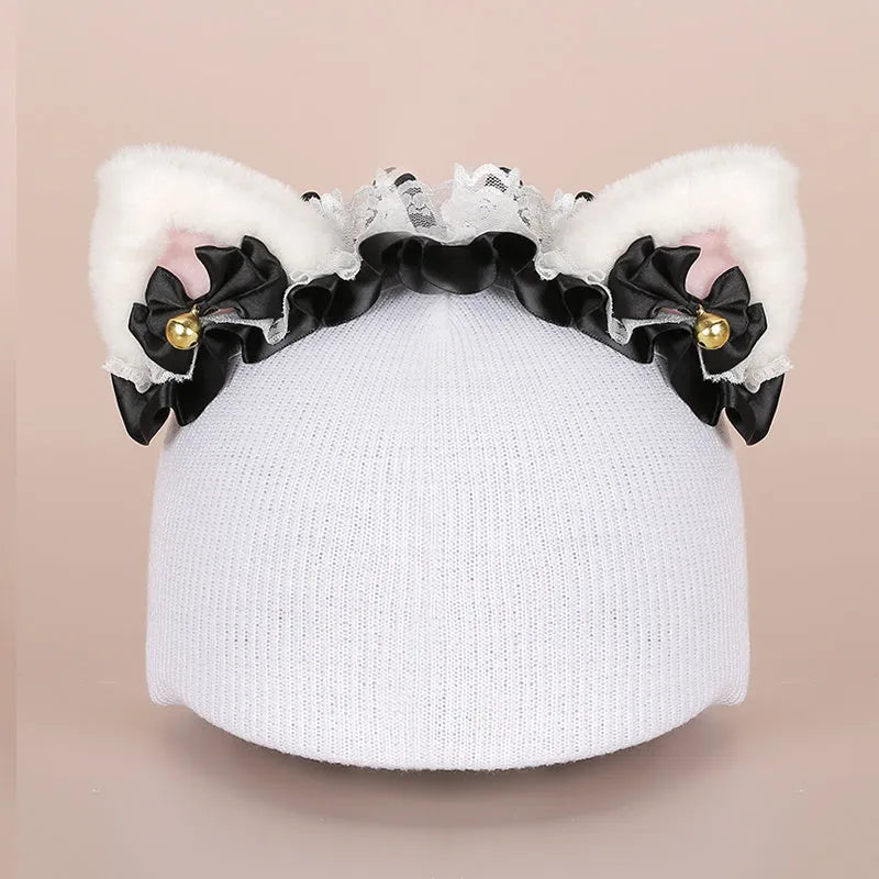 Plush fabric ski helmet decoration with cartoon design on a black ski helmet.