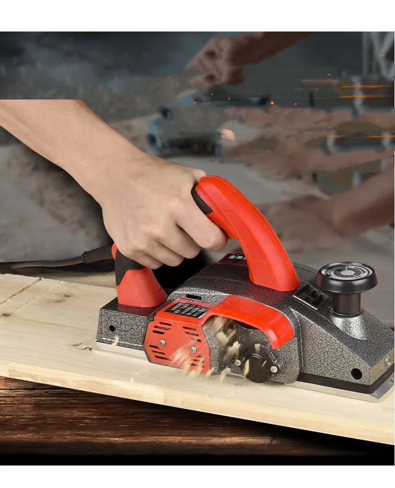 Red electric wood planer tool with aluminium shell showing 82mm cutting width