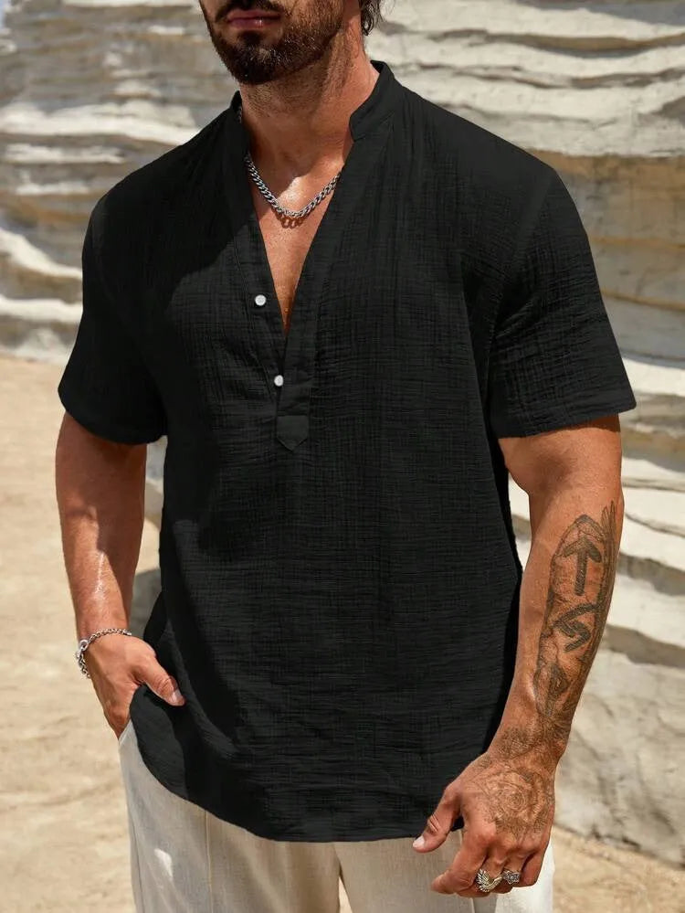 Men's solid colour stand collar short-sleeved casual shirt laid flat, showing slit detail and thin fabric.