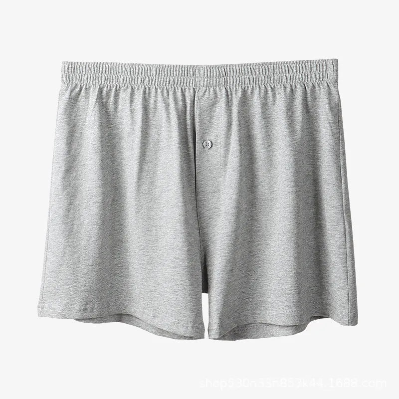 Men's solid colour loose-fit cotton boxer shorts on a white background, showing high waist and leg openings.
