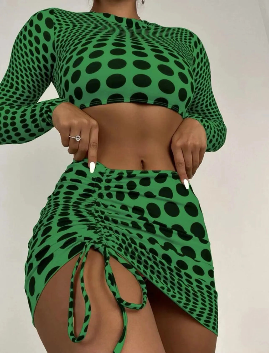 Green and yellow polka dot women's swimsuit three-piece set with top, skirt, and bra.