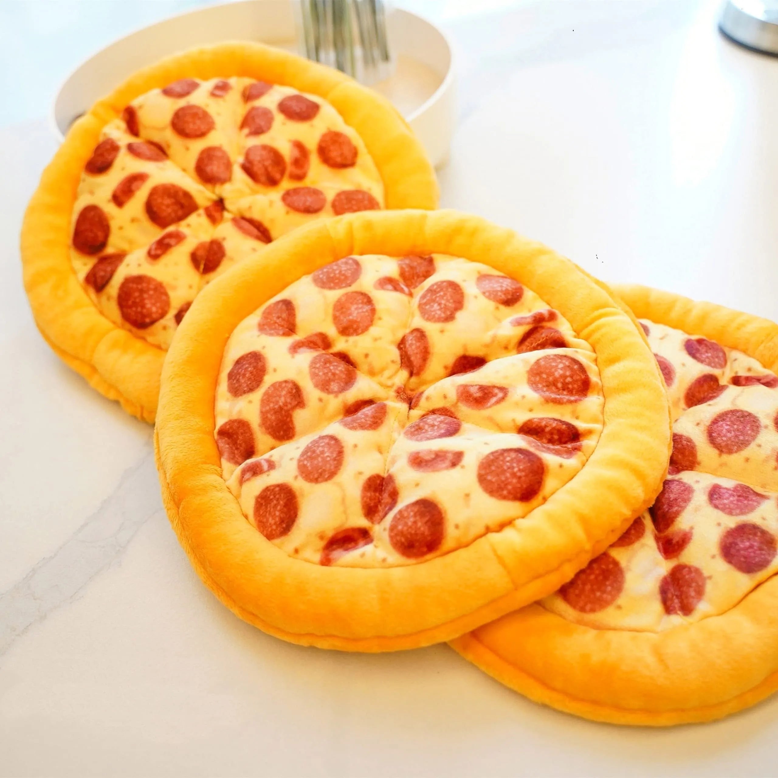 Yellow pizza slice shaped plush dog chewing toy with a squeaker for medium and small dogs.