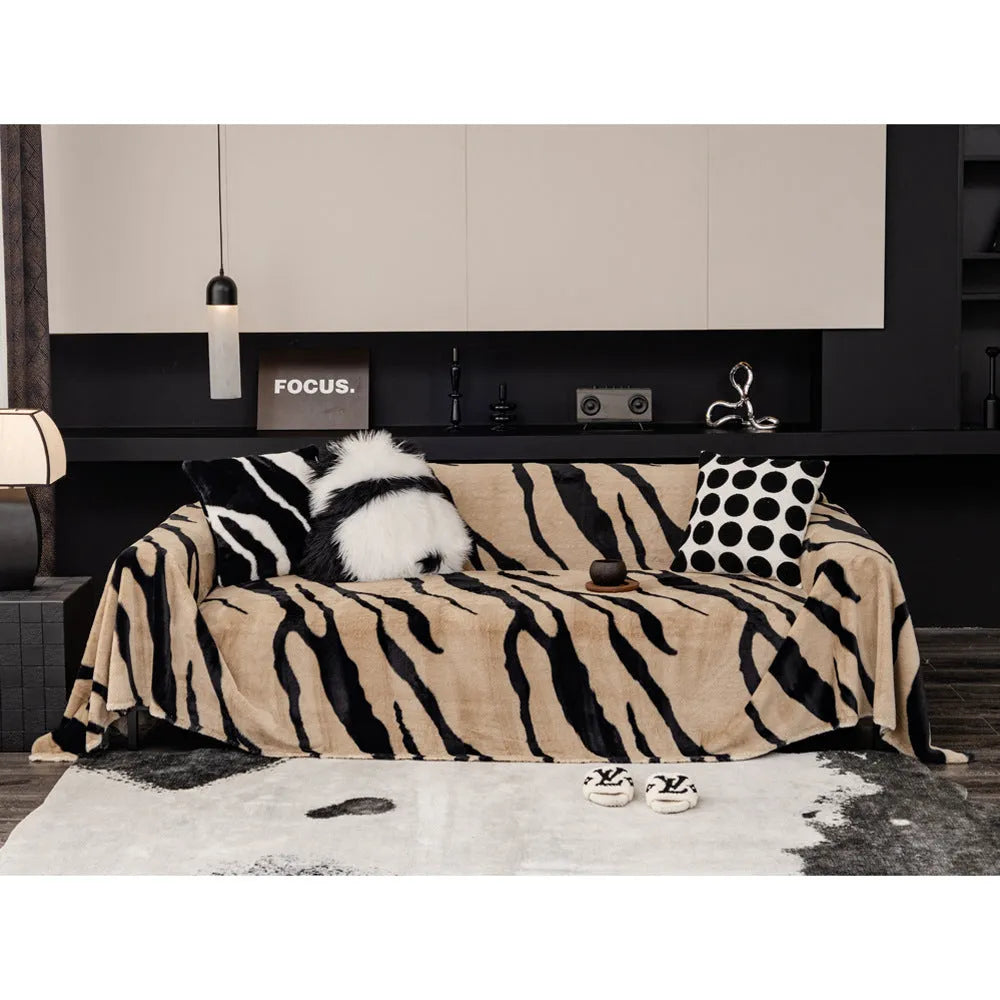 Zebra pattern flannel sofa slipcover in caramel colour, shown draped over a sofa.