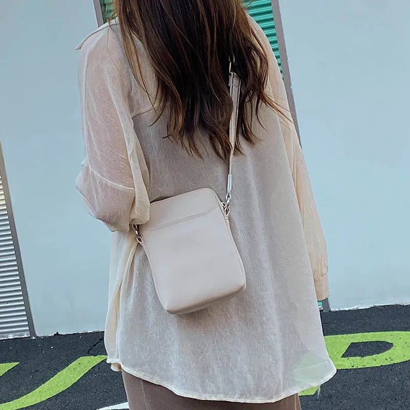 Solid colour women's crossbody phone bag in black, beige, khaki, or green.