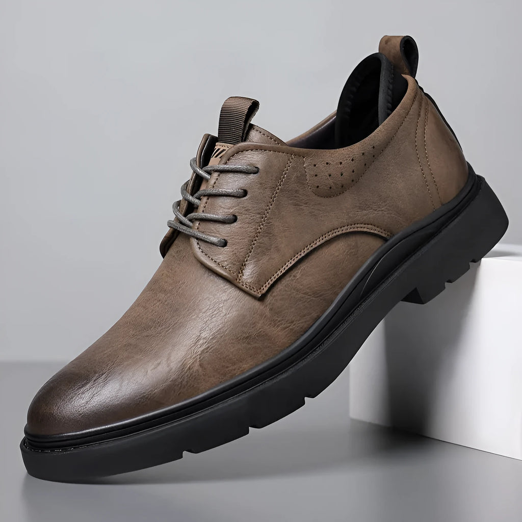 Men's black and brown cowhide leather sneaker shoes with rubber soles and decorative sewing lines.