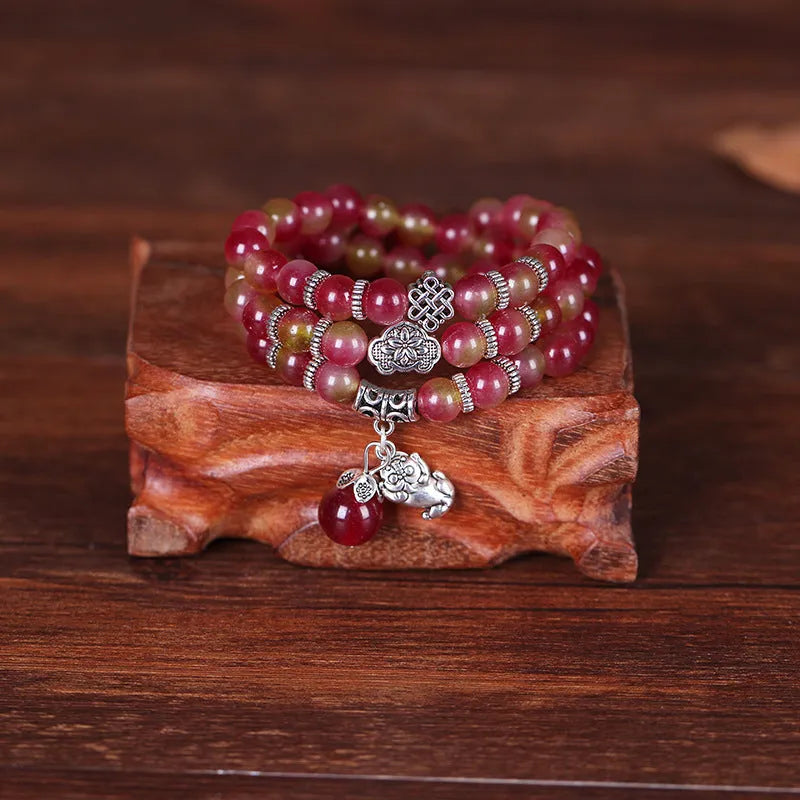 Watermelon crystal bracelet with Chinese knot detailing in geometric national style design